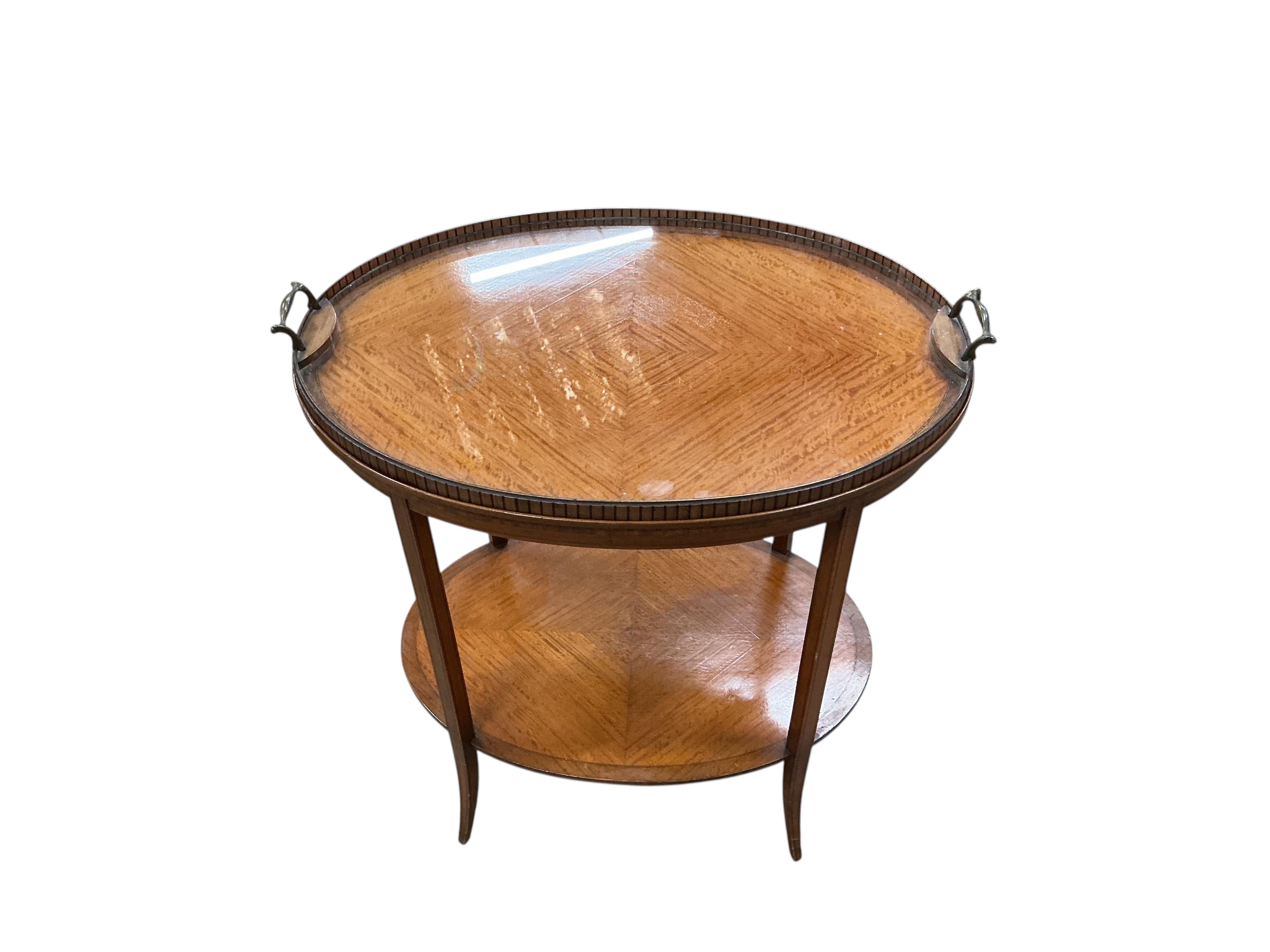 An Edwardian oval satinwood tray top etagere, width 67cm, depth 45cm, height 75cm